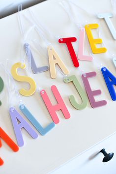 colorful magnets that spell out the word state palace on a white surface with black pegs