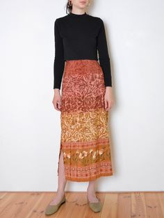 Beautiful vintage skirt made of silky fabric with unique print of geometric and organic ornaments with floral pattern running around the bottom hem. Earthy tones of brown, beige, brick red and rosewood pink with a hint of green and white. Two side slits. Closes with side zip and button. Comfortable elastic on the back of the the waistband. Era: 90's Fabric: polyester Condition: very good Estimated size: M / L (please, check the measurements) Measurements (measured flat): Waist (elastic unstretch Bohemian Lined Maxi Skirt For Fall, Bohemian Brown Skirt For Fall, Beige Bohemian Maxi Skirt, Beige Bohemian Relaxed Maxi Skirt, Fall Bohemian Brown Skirt, Brown Flowy Floral Print Skirt, Flowy Brown Floral Print Skirt, Flowy Brown Skirt With Floral Print, Brown Flowy Skirt With Floral Print