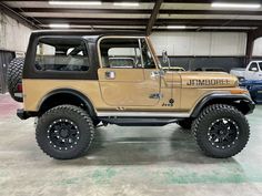 a tan jeep is parked in a garage