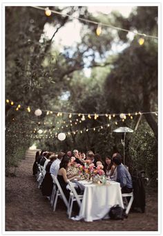 a group of people sitting around a dinner table