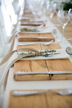 the table is set with place settings and utensils for guests to sit at