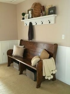 a wooden bench sitting in the corner of a room