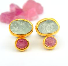 "Rough Aquamarine and Pink Tourmaline Stud Earrings made out of 18 karat Gold plated Sterling Silver. 100% Handmade Jewellery. AQUAMARINE: Aquamarine, the birthstone of March, has a rich color and has long been a symbol of youth, health and hope. Its mesmerizing color ranges from pale to deep blue and are reminiscent of the sea. A perfect birthstone for March, the Aquamarine creates a beautiful accent to spring and summer wardrobes. TOURMALINE: Tourmaline is the newer October birthstone. The nam Tourmaline Multi-stone Earrings For Gift, Tourmaline Multi-stone Earrings As Gift, Multi-stone Tourmaline Earrings As A Gift, Tourmaline Earrings, October Birthstone, Earrings Stud, Raw Gemstones, March Birth Stone, October Birth Stone