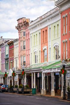 a row of multi - colored buildings on a city street