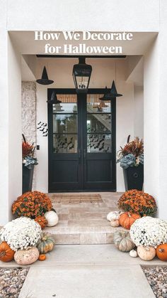 the front entrance to a home with pumpkins and flowers