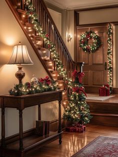 christmas decorations on the banisters and stairs in a home decorated with holiday lights