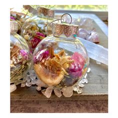 an ornament filled with flowers sitting on top of a wooden table next to other items