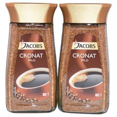 two jars of ground coffee sitting next to each other