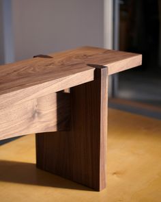 a wooden bench sitting on top of a hard wood floor