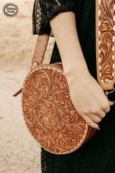 The STOCKYARD TOOLED CANTEEN BAG is a unique combination of style and functionality. The tooled genuine leather design adds a touch of rustic charm, while the adjustable buckstitch strap ensures comfort while carrying. Perfect for any adventure or everyday use!Strap: 52"Bag: 10.5" X 2.5" Leather Canteen, Western Chic Fashion, Turquoise Purse, Classy Cowgirl, Western Tack, Tooled Leather Purse, Western Purses, Buckles Fashion, Ethical Shopping