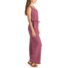 Made from super soft, lightweight stretchy fabric, this jumpsuit is designed to be worn for any season or occasion, making it a staple in your wardrobe. The flattering relaxed fit and wide-leg style with side pockets add a touch of casual sophistication, while the open V-neck and elastic waistband with a drawstring tie create a flattering silhouette that complements any body type. Dress it down with your favorite sandals for a laid-back daytime look or dress it up with wedges and sparkling state Spring Solid Jumpsuits And Rompers With Side Pockets, Spring Solid Color Jumpsuits And Rompers With Side Pockets, Solid Color Jumpsuits And Rompers For Summer Lounging, Solid Jumpsuits And Rompers For Summer Lounging, Solid Jumpsuits And Rompers With Side Pockets For Spring, Beach Jumpsuits And Rompers With Elastic Waistband, Solid Jumpsuits And Rompers With Tie Waist For Loungewear, Solid Color Loungewear Jumpsuit With Tie Waist, Spring Comfortable Relaxed Fit Jumpsuits And Rompers