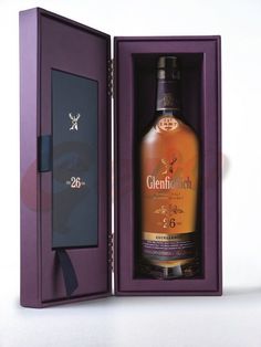 a bottle of whisky in a purple box