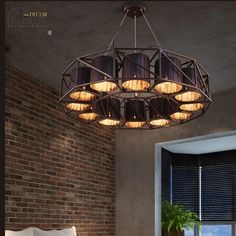 a bedroom with brick walls and a round chandelier hanging from the ceiling over a bed