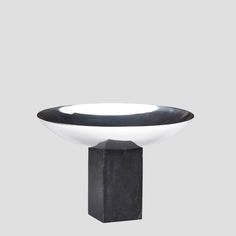 a black and white bowl sitting on top of a table