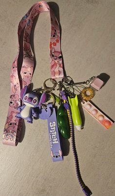 a bunch of items that are laying on the floor next to each other, including a lanyard and keychain