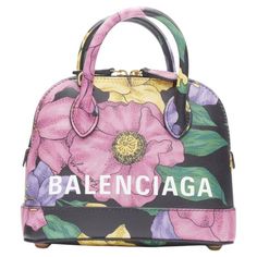 BALENCIAGA Ville XXS black floral logo print top handle crossbody bag Reference: TGAS/B01535 Brand: Balenciaga Designer: Demna Model: Ville XXS Material: Leather Color: Multicolour Pattern: Floral Closure: Zip Lining: Leather Extra Details: Ville XXS. Black base with floral print. Rolled top handle. Top zip closure. Detachable crossbody strap. Metal feet at base. Made in: Italy CONDITION: Condition: Unworn in mint condition, with tags. Comes with: Designer tags. One dust bag. MEASUREMENTS: Width Bag Reference, Bags Balenciaga, Leather Jewels, Hawaiian Flower, Bowling Bag, Floral Logo, Bowling Bags, Frame Bag, Flower Bag