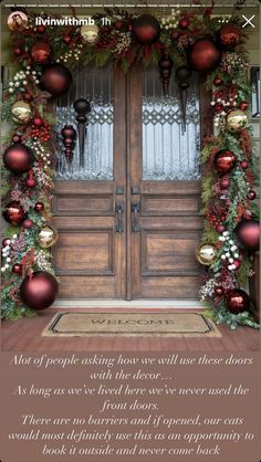 the front door to a house decorated for christmas with ornaments and greenery on it