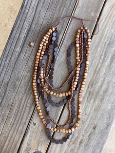 This beautiful handmade multi strand necklace with wood & resin beads will add the perfect touch to your bohemian look. One size fits all. Product Dimensions: Approximately 34" long adjustable