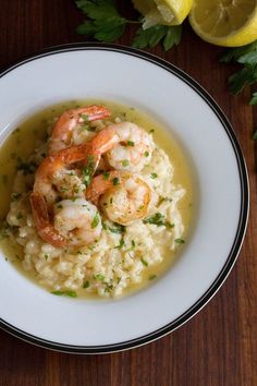 shrimp and grits served in a white bowl with garnish