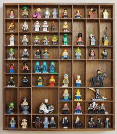 a wooden shelf filled with lots of legos