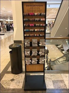 a display case in the middle of a shopping mall filled with cards and paper origami