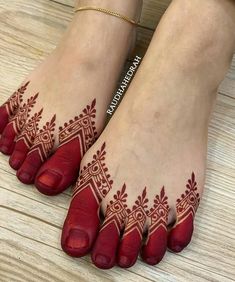 a woman's feet with hennap on it and her hands painted red