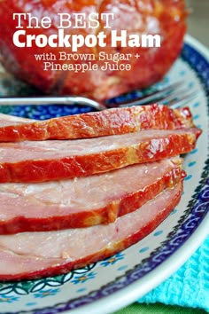 sliced ham on a blue and white plate next to an apple with the words slow cooker brown sugar ham