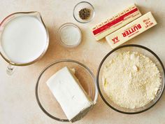 ingredients to make cheesecake sitting on a counter top, including milk, butter and flour