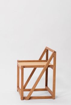 a wooden chair sitting on top of a white floor