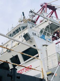 a large white boat sitting on top of a body of water