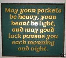 a green sign with gold lettering on it that says may your pockets be heavy, your heart be light and may god luck pursue you each morning and night