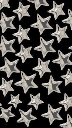 many shiny silver stars on a black background