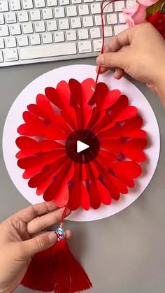 someone is making a flower out of paper