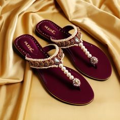 The image shows a pair of elegant, open-toed, heeled shoes. The shoes are a deep red color and are adorned with intricate, white floral embroidery. The background is a soft, white, sheer fabric which adds to the overall aesthetic appeal of the image. White Floral Embroidery, Pretty Sandals, Footwear Design, Sari Blouse Designs, Classy Shoes, Bridal Sandals, Cute Cartoon Images, Fancy Shoes, Sari Blouse