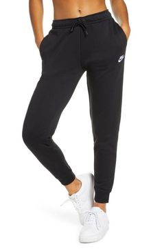 Nike Women's Sportswear Essential Fleece Pants Style#: BV4095-010 Black Size: X-Large (XS=0-2, S=4-6, M=8-10, L=12-14, XL=16-18 (16W), XXL=20-22 (18W)). Whether you're working out or hanging out, you'll feel comfortable in these jogger sweatpants made from supersoft semi-brushed fleece. A drawcord waistband adjusts the fit, while ribbed cuffs let you show off your favorite kicks. High rise. 30" inseam; 9" leg opening; 10 3/4" front rise; 14 1/2" back rise Elastic/drawstring waist Side-seam pocke Black Nike Sweatpants Outfits, Black Nike Sweatpants, Sweatpants Outfits, Sportswear Outfits, Athleisure Brands, Cute Sweatpants, Sweatpants Outfit, Nike Sweats, Joggers Outfit