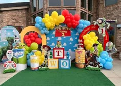 an outdoor birthday party with balloons and decorations