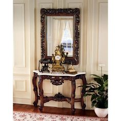 an ornate wooden table with a mirror on it