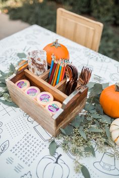 a wooden box filled with lots of different types of food on top of a table