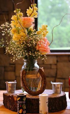 a vase filled with flowers sitting on top of a wooden table