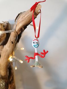 a christmas ornament hanging from a tree branch