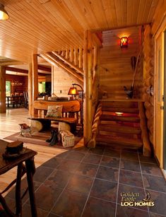 the inside of a log cabin with stairs