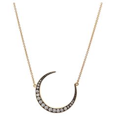 0.43 carat of pave-set diamond expand the surface of this crescent moon pendant strung on 18 karat yellow gold chain. A piece one can't help but gravitate toward. Luxury White Gold Crescent Necklace, Luxury Crescent Necklace For Anniversary, Elegant Crescent White Gold Diamond Necklace, Luxury Crescent White Gold Necklace, Elegant Diamond Necklace With Moon Phase Detail, Elegant Diamond Necklace With Moon Phase, Luxury Crescent Necklace With Diamond Accents, Elegant Diamond Moon Phase Jewelry, Elegant Crescent Rose Cut Diamond Jewelry