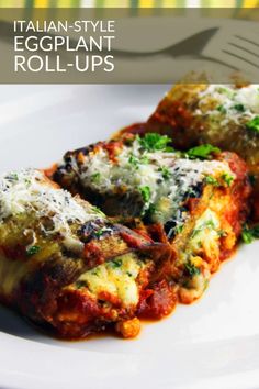 an eggplant roll - ups on a white plate with parmesan cheese