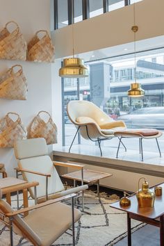 a living room filled with furniture next to a window covered in lots of light fixtures