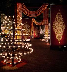 an outdoor area with lit candles and decorations