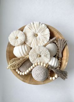 an arrangement of seashells on a wooden plate