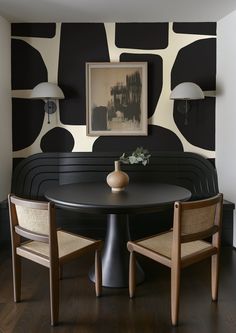 a black and white dining room with two chairs