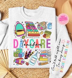 a white shirt with the words day care on it next to some straws and other items