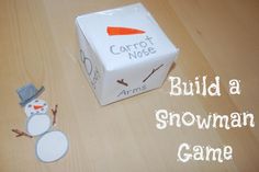 a paper snowman is next to a cardboard box that says build a snowman game