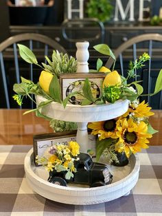 three tiered tray with flowers and pictures on it